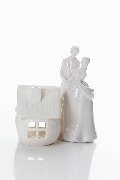 istock Bridal couple figurine and house 531243437