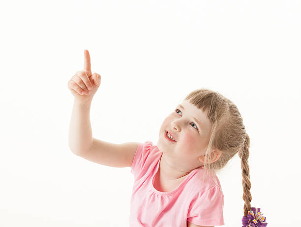 istock Smiling little girl indicating something up 531244840