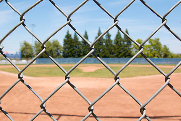 baseballfeld durch zaun - baseball dirt softball baseball diamond stock-fotos und bilder