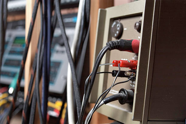 Closeup of a sound amplifier with electric and audio cables, shallow depth of field indoor shot