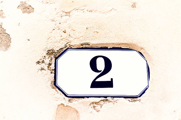 istock Number 2 Vintage Address Tile On Old Chipped White Wall 531247934
