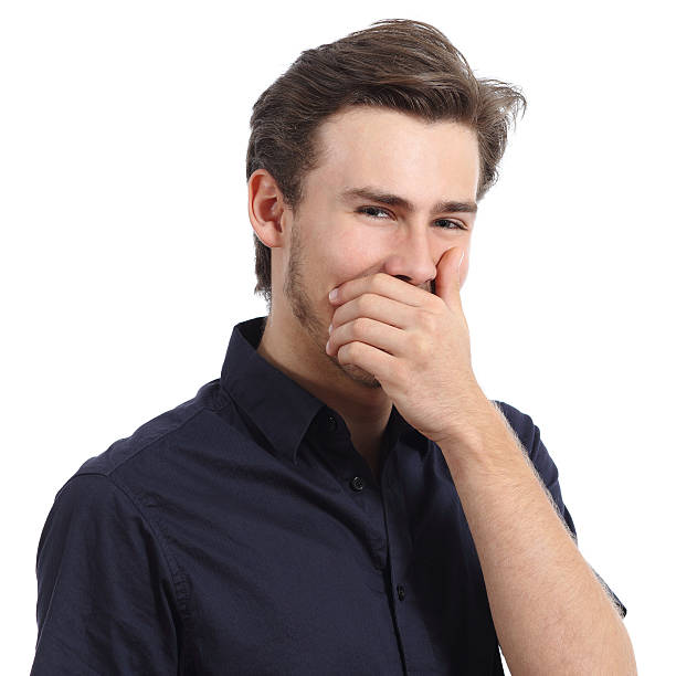 istock Handsome man laughing while covering his mouth with a hand 531250933
