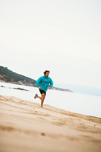istock Athlete exercies in morning training, jogging on beach 531250942
