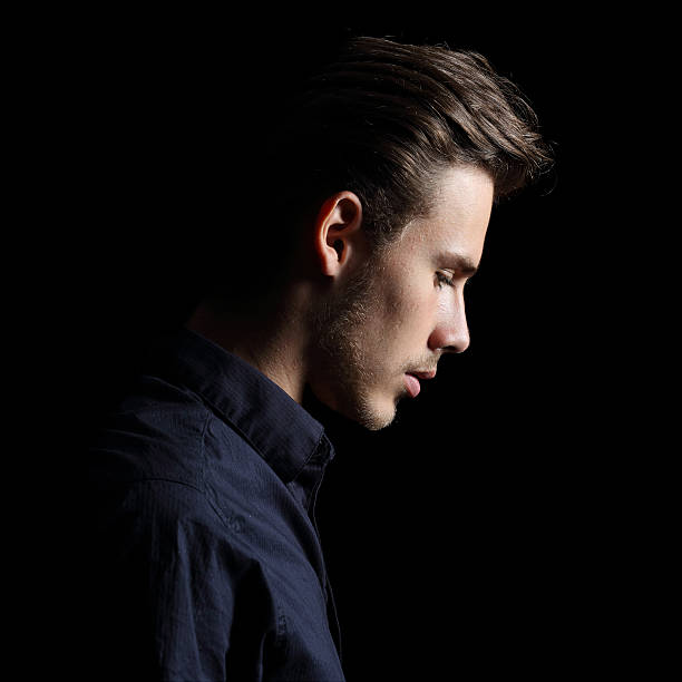 istock Profile of a sad man face crestfallen on black 531251123