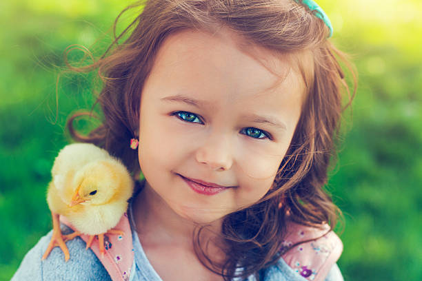 istock Little girl with chicken 531252268