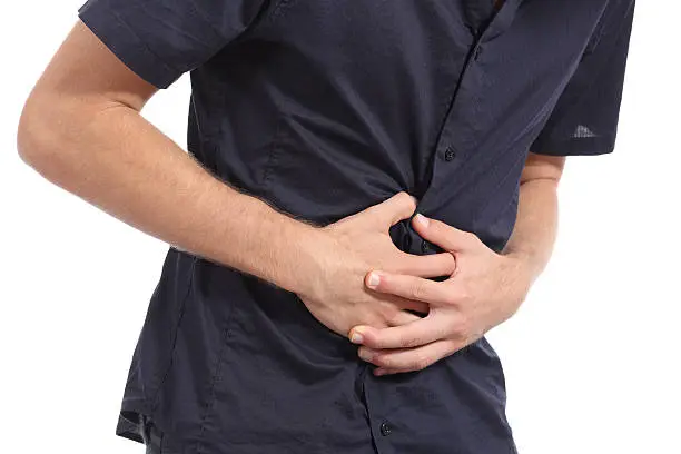 Photo of Casual man with stomach ache