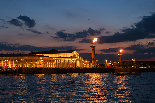 Night view of the rostral columns, Exchange Building, Neva from the Palace Embankment. In the rostral column ignited gas flares. St. Petersburg, Russia