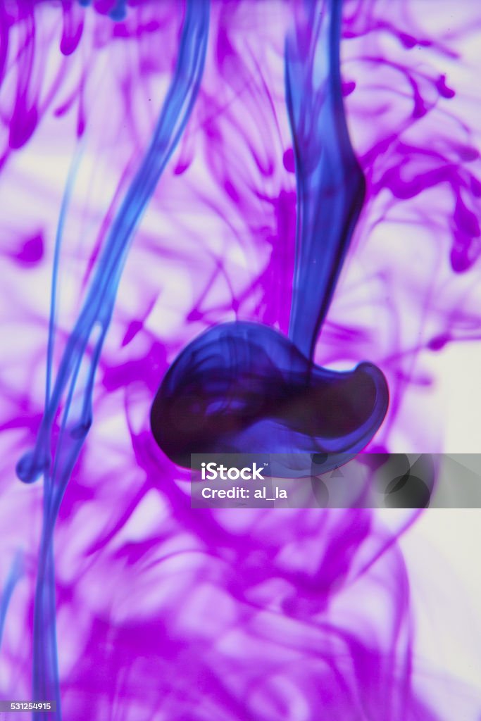 Blue and violet liquid in water Blue and violet liquid in water making abstract forms 2015 Stock Photo