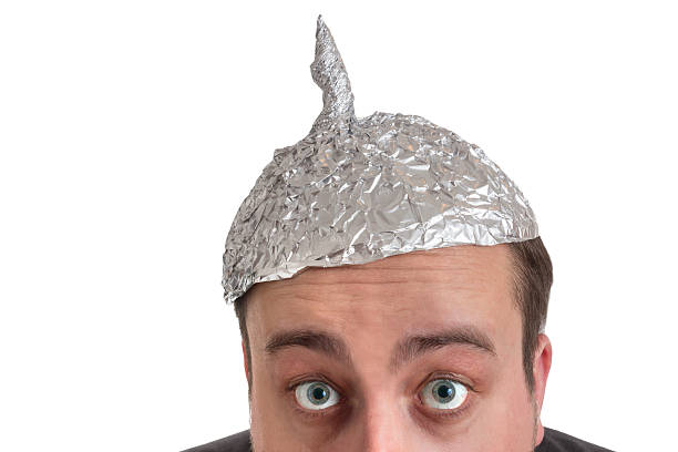 conspiracy Freak with aluminum foil head distraught looking conspiracy believer in suit with aluminum foil head isolated on white background conspiracy photos stock pictures, royalty-free photos & images