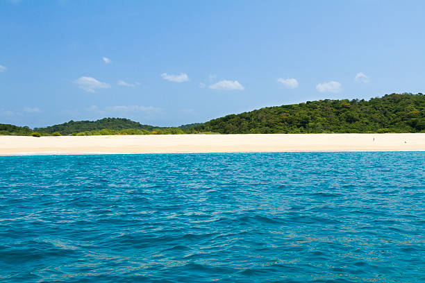 Two park guards walking along the beach at Cacaluta Bay in Huatulco