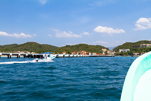 Two boats arriving to the Huatulco Pier at the Santa Cruz Bay