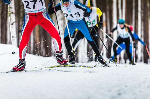 Kyshtym, Russia - March 26, 2016: group of male skiers going uphill during XYII Ski marathon