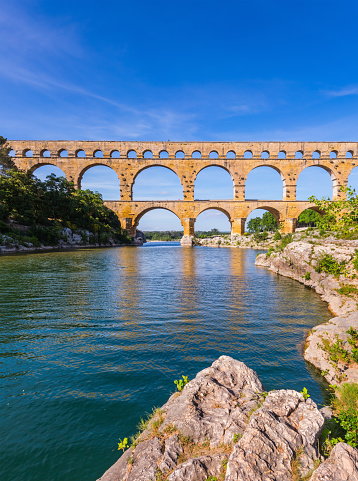 Three-storied aqueduct of Pont du Gard - the highest in Europe. The bridge was built at the time of Roman Empire on river Gardon. Provence, spring sunny day
