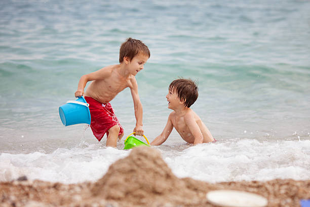 istock Two children, boy brothers, playing on the beach 531258880