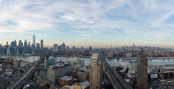 The New York City Skyline at sunset with the Brooklyn Bridge and the DUMBO area in the foreground. Also shows the Manhattan Bridge. This photo shows almost the entire New York City Skyline.