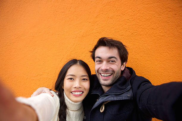 istock Smiling young couple taking a selfie with mobile phone 531262161