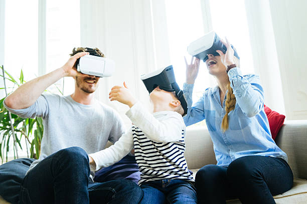 Family having fan experiencing virtual reality at home.