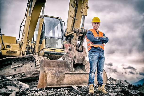 Earth Digger Driver Earth Digger Driver at construction site maintenance engineer photos stock pictures, royalty-free photos & images