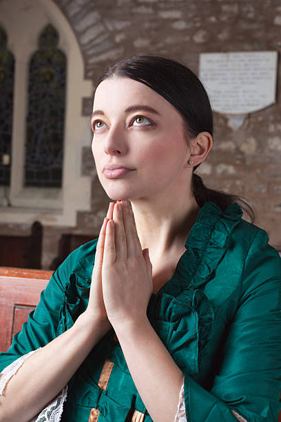 istock Victorian Lady Praying In Church 531265805