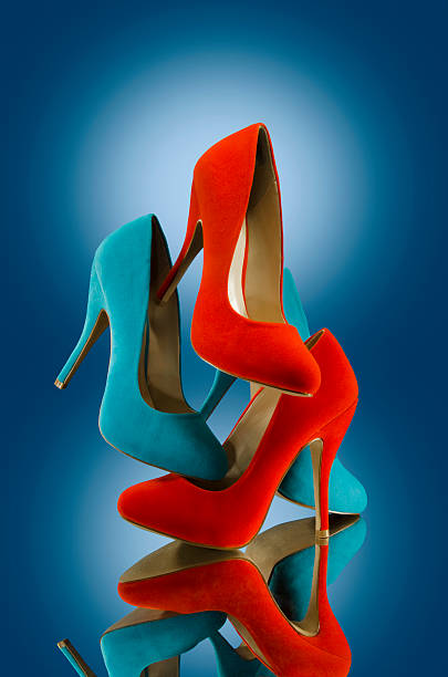 Women's red and blue colored High Heel shoes on mirror stock photo