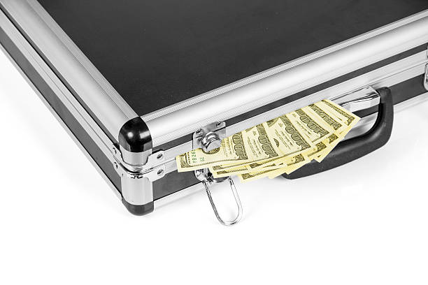 istock Full suitcase with hundred dollar bills isolated on white 531266546