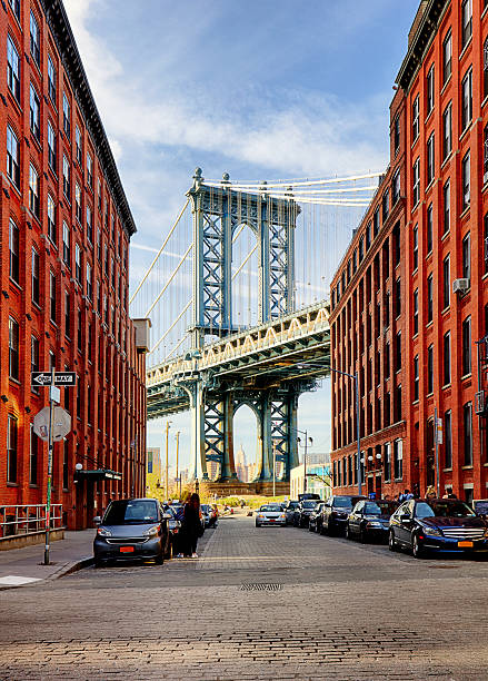 Manhattan Bridge from an alley in Brooklyn, New York Manhattan Bridge from an alley in Brooklyn, New York dumbo new york photos stock pictures, royalty-free photos & images