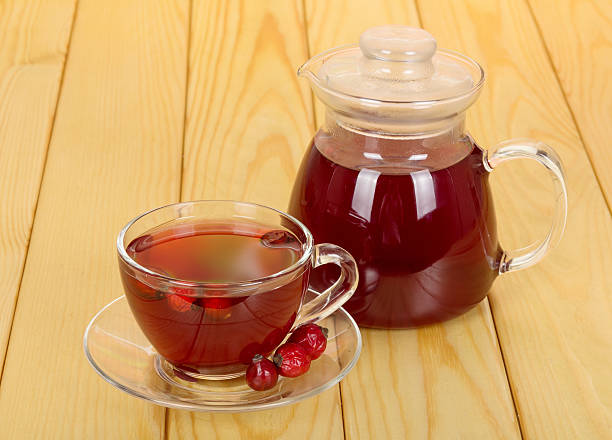 istock Jug and cup of rosehip drink on the background  light 531267326