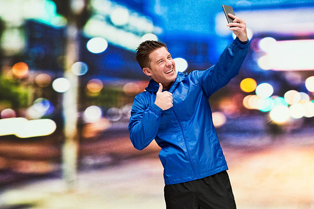 istock Smiling man taking a selfie at night in the city 531267846