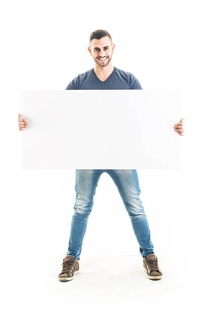 istock Cheerful Bearded Man Holding a Blank Sign 531268053