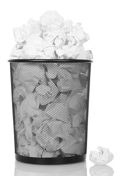 istock Overflowing metal trash bin from paper isolated on white 531268180
