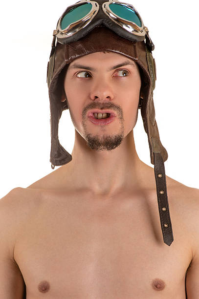 istock man bare-chested in flight helmet and goggles looking away 531268836