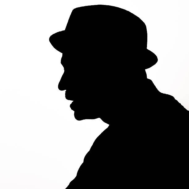 Black silhouette of a man wearing a hat and a mustache in black against a white background.