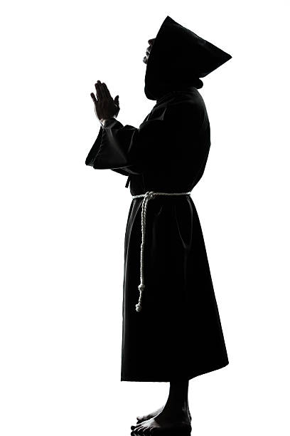 istock man monk priest silhouette praying 531277139