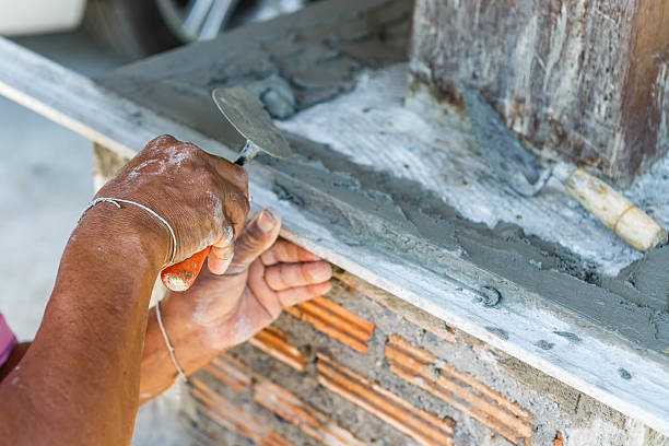 istock plasterer concrete worker at wall of house construction 531280617