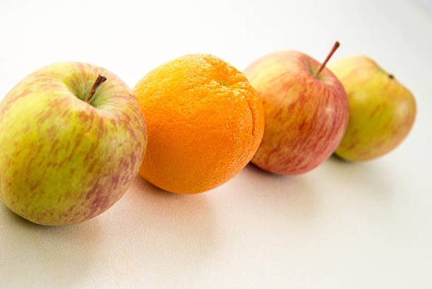 istock line of apples with one orange 531281253