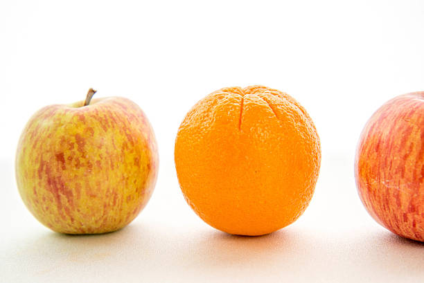 istock line of apples with one orange 531281265