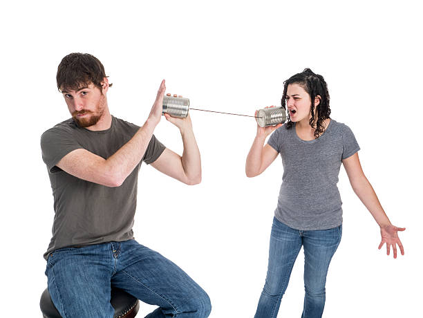 Young Couple Communicates with Tin Can Phones stock photo