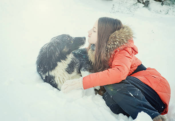 istock Girl with a dog in the snow. 531282151