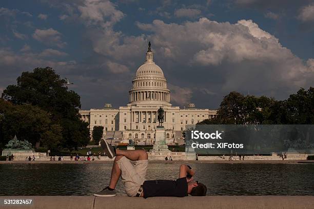 Young Man Lying On His Back Photographying The Capitol Hill Stock Photo - Download Image Now