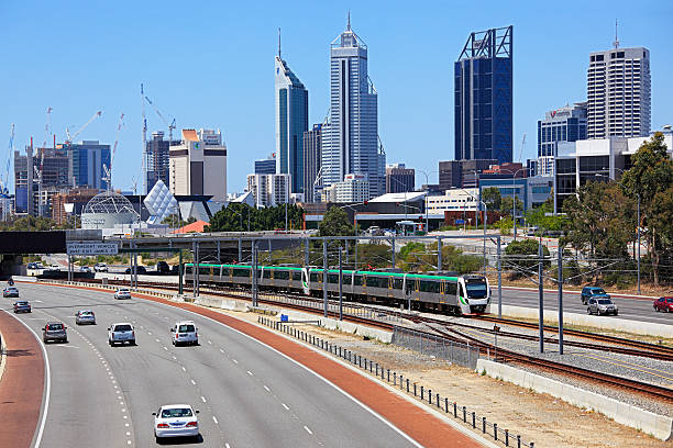 perth paesaggio urbano con treno elettrico corre lungo autostrada. - train australia electric train image foto e immagini stock