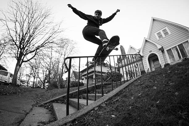 Young man skateboarding on handrail