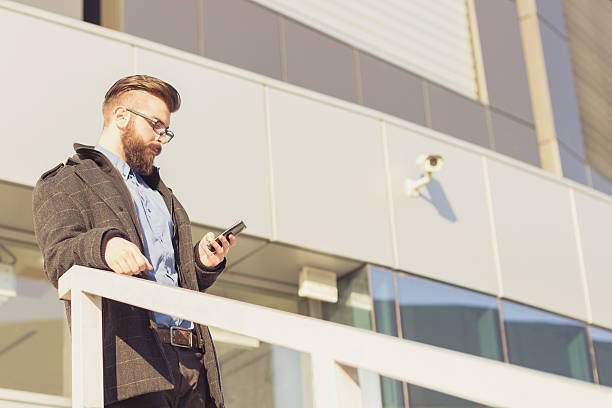 istock Modern businessman sending text message with his mobile phone 531290279