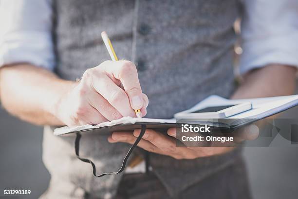 Close Up Hands Man Writing On Diary And Smartphone Stock Photo - Download Image Now - 2015, Adult, Business