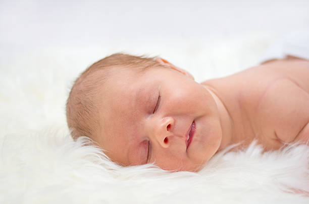 istock Baby speeling on a fur bedspread 531292189