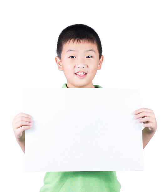 istock Smiling boy standing with empty horizontal blank paper in hands 531292263