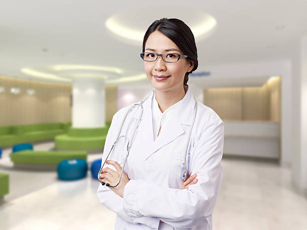 asian doctor portrait of a female asian doctor in hospital lobby. click for more: japanese female doctor stock pictures, royalty-free photos & images