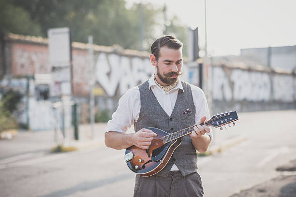 istock handsome big moustache hipster man playing mandolin 531292431