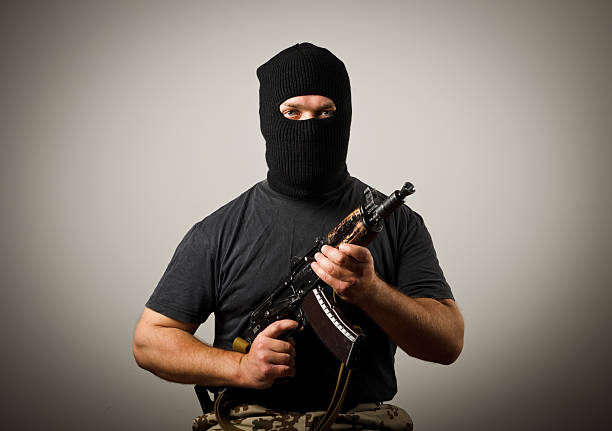 Man with gun Man in mask with gun. gunman stock pictures, royalty-free photos & images