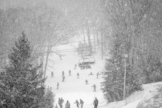 Bunny slope at the Ski Resort under snowfall Skiing at the Bunny Slope under the snowfall. Ski Resort, Poconos, Pennsylvania  the poconos stock pictures, royalty-free photos & images