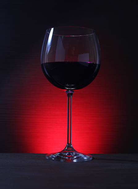 istock Glass of Red Wine with Lights Background 531301937